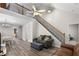 Inviting living room featuring hardwood floors, staircase, and vaulted ceilings with a fan fixture at 331 Franklin Ln, Acworth, GA 30102
