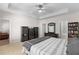 Bright main bedroom boasting a tray ceiling, fan, and adjoining bathroom and reading area at 331 Franklin Ln, Acworth, GA 30102