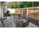 Cozy back patio featuring outdoor seating, with a view of the privacy fence and green trees at 331 Franklin Ln, Acworth, GA 30102