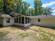 Rear view of the home, featuring a screened in porch, and nice back yard at 345 Forest Valley Rd, Lawrenceville, GA 30046