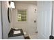 Well lit bathroom with tile shower, modern sink and door giving entry at 345 Forest Valley Rd, Lawrenceville, GA 30046