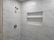 Modern shower featuring sleek fixtures and a recessed shower niche for storage at 345 Forest Valley Rd, Lawrenceville, GA 30046