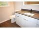 Modern bathroom featuring a stylish vanity with gray countertop and sleek white cabinetry at 345 Forest Valley Rd, Lawrenceville, GA 30046