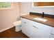 Modern bathroom featuring a stylish vanity with gray countertop and sleek white cabinetry at 345 Forest Valley Rd, Lawrenceville, GA 30046