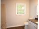 Bathroom featuring a tub and a modern vanity with dark countertop and wooden floors at 345 Forest Valley Rd, Lawrenceville, GA 30046