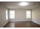This large bedroom features wood-look floors and lots of natural light at 345 Forest Valley Rd, Lawrenceville, GA 30046