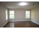 This large bedroom features wood-look floors and lots of natural light at 345 Forest Valley Rd, Lawrenceville, GA 30046