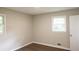 This bedroom features neutral walls, wood-look flooring, and a window for natural light at 345 Forest Valley Rd, Lawrenceville, GA 30046