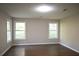 This large bedroom features wood-look floors and lots of natural light at 345 Forest Valley Rd, Lawrenceville, GA 30046