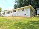 A charming white brick ranch-style home with a lush green front lawn, and white trim at 345 Forest Valley Rd, Lawrenceville, GA 30046