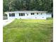 Charming white brick ranch-style home with lush green front lawn and concrete driveway at 345 Forest Valley Rd, Lawrenceville, GA 30046