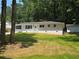 Landscaped front lawn and charming curb appeal define this single-story home at 345 Forest Valley Rd, Lawrenceville, GA 30046