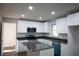 Well-lit kitchen with modern white cabinets, stainless steel appliances, and a gray countertop island at 345 Forest Valley Rd, Lawrenceville, GA 30046