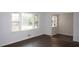 Bright living room featuring refinished hardwood floors and multiple windows for natural light at 345 Forest Valley Rd, Lawrenceville, GA 30046