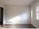 Sunlit living room featuring hardwood floors, fresh white walls and a new front door at 345 Forest Valley Rd, Lawrenceville, GA 30046