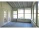 This sunroom offers bright natural light with multiple windows and an access door at 345 Forest Valley Rd, Lawrenceville, GA 30046
