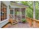 Covered back porch, complete with furniture, provides a relaxing outdoor retreat surrounded by lush green foliage at 3741 Windhurst Dr, Lilburn, GA 30047