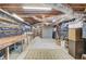 Unfinished basement with shelving and work tables offers ample storage and project space at 3741 Windhurst Dr, Lilburn, GA 30047