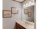 Bathroom vanity features a mirror, a sink, and neutral wall art that creates a serene, cohesive design at 3741 Windhurst Dr, Lilburn, GA 30047
