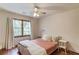 Bedroom with hardwood floors, a ceiling fan, and a large window with curtains at 3741 Windhurst Dr, Lilburn, GA 30047