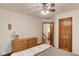 Bedroom featuring a ceiling fan, a dresser, laminate wood flooring, and a hall closet at 3741 Windhurst Dr, Lilburn, GA 30047