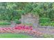 Stone community entrance sign with manicured flower beds and lush greenery, welcoming residents and guests at 3741 Windhurst Dr, Lilburn, GA 30047