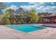 View of the rectangular community pool and nearby covered pavilion, surrounded by mature trees at 3741 Windhurst Dr, Lilburn, GA 30047