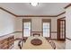 Bright dining room with wood trim, light wood floors, and abundant natural light from two large windows at 3741 Windhurst Dr, Lilburn, GA 30047
