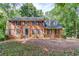 Charming two-story brick home with black shutters and a well-manicured front yard at 3741 Windhurst Dr, Lilburn, GA 30047