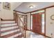 Inviting foyer with hardwood floors, staircase, and a solid wood front door with sidelights at 3741 Windhurst Dr, Lilburn, GA 30047