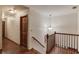 Upstairs hallway with beautiful wood floors, trim, and doors at 3741 Windhurst Dr, Lilburn, GA 30047