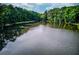 Picturesque view of the community lake, perfect for relaxing or enjoying water activities amidst a serene setting at 3741 Windhurst Dr, Lilburn, GA 30047