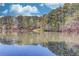 Beautiful lake view reflecting the surrounding trees and sky, creating a tranquil and inviting atmosphere at 3741 Windhurst Dr, Lilburn, GA 30047