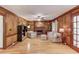 Spacious living room with wood paneling, built-in shelving, fireplace, hardwood floors, and lots of light at 3741 Windhurst Dr, Lilburn, GA 30047