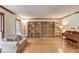 Bright living room featuring hardwood floors, a large window, and custom shelving at 3741 Windhurst Dr, Lilburn, GA 30047