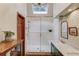 Main bathroom featuring a glass enclosed shower, skylight, and a vanity with a marble countertop at 3741 Windhurst Dr, Lilburn, GA 30047