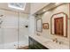 Main bathroom featuring a glass enclosed shower, double vanity, and a skylight at 3741 Windhurst Dr, Lilburn, GA 30047