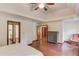 Spacious main bedroom with wood floors and multiple doors at 3741 Windhurst Dr, Lilburn, GA 30047