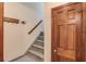 Hallway and stairway featuring a coat rack and grey concrete flooring, leading to the upper level at 3741 Windhurst Dr, Lilburn, GA 30047