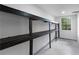 Spacious basement with storage shelving and natural light from a bright window at 4131 West Village Pkwy, Ellenwood, GA 30294