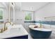 A bathroom with double sink, bathtub and rectangular mirrors above each sink at 4131 West Village Pkwy, Ellenwood, GA 30294