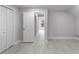 Bright bedroom shows closet and door to another room, with light gray flooring at 4131 West Village Pkwy, Ellenwood, GA 30294