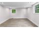 A bedroom with wood flooring, two windows and base molding around the perimeter of the room at 4131 West Village Pkwy, Ellenwood, GA 30294