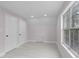 A bedroom with wood flooring, two closets and a window allowing in natural light at 4131 West Village Pkwy, Ellenwood, GA 30294