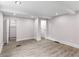 A bedroom with wood flooring, a closet and base molding around the perimeter of the room and a door at 4131 West Village Pkwy, Ellenwood, GA 30294