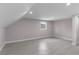 Well-lit bedroom with neutral walls and grey flooring at 4131 West Village Pkwy, Ellenwood, GA 30294