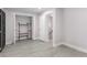 Bright bonus room shows black french doors and additional storage with light gray flooring at 4131 West Village Pkwy, Ellenwood, GA 30294