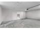Unfinished garage showcasing ample space for storage and a doorway to the side at 4131 West Village Pkwy, Ellenwood, GA 30294