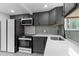 Modern kitchen with stainless steel appliances and sleek gray cabinets at 4131 West Village Pkwy, Ellenwood, GA 30294