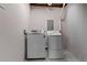 Bright laundry room with white washer and dryer at 4131 West Village Pkwy, Ellenwood, GA 30294